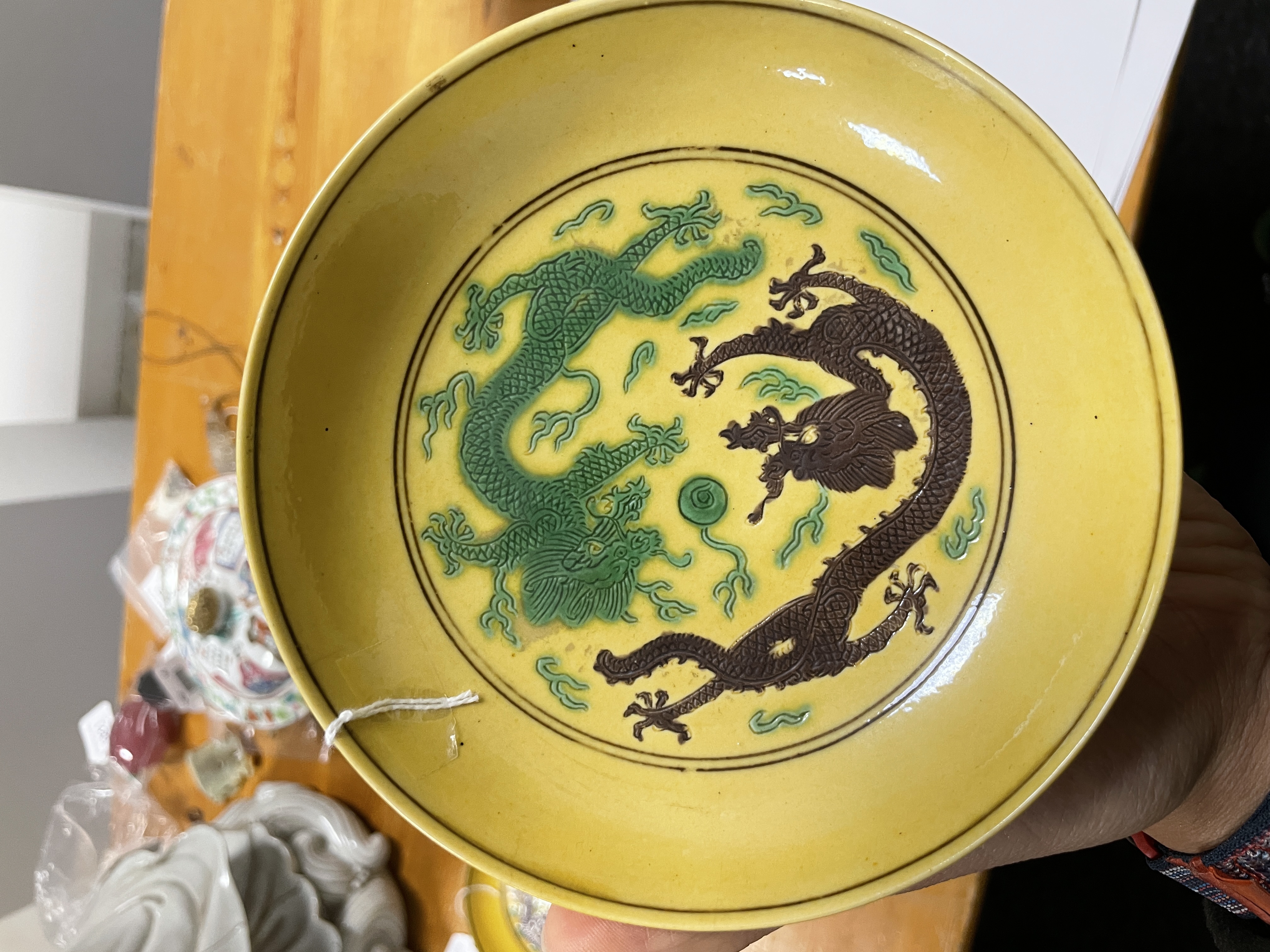 A Chinese Imperial porcelain yellow and green and aubergine-glazed 'dragon' saucer dish